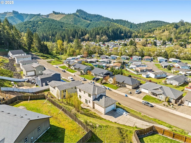 aerial view with a residential view, a mountain view, and a wooded view