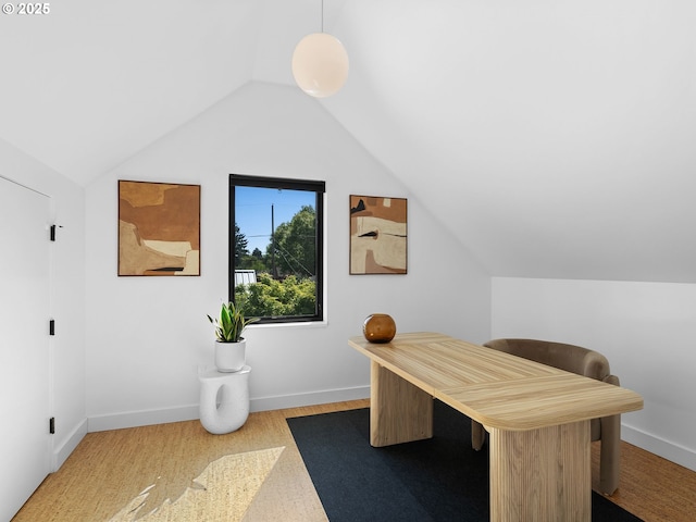 office area featuring vaulted ceiling and baseboards
