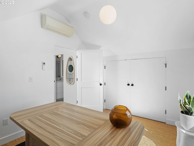 interior space with a wall mounted air conditioner and vaulted ceiling