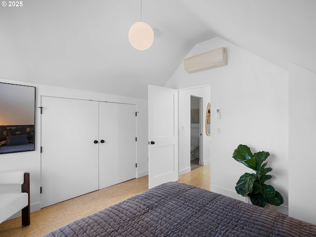 bedroom with an AC wall unit and lofted ceiling
