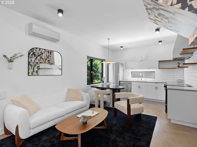 living area with a wall mounted AC and concrete flooring