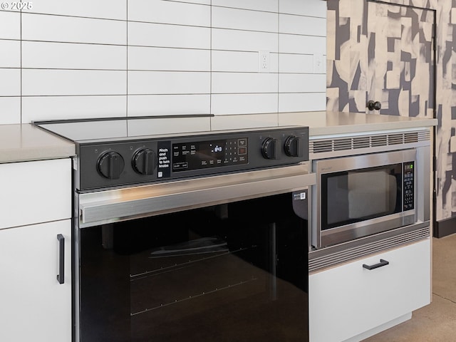 kitchen view of stainless steel microwave, oven, and light countertops