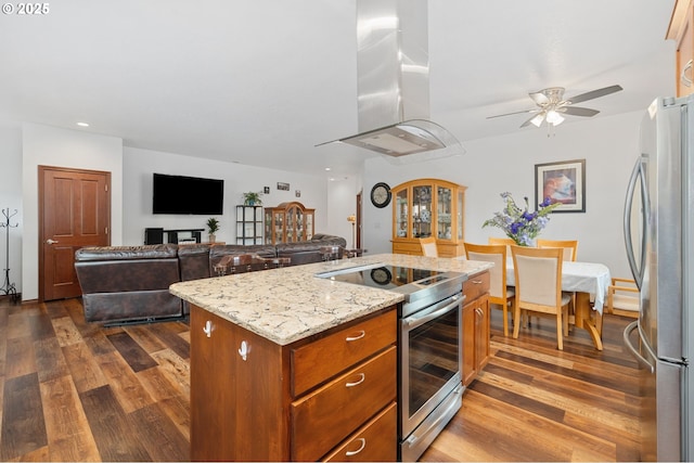 23072 SW Mansfield St, Sherwood, OR 97140 - kitchen featuring stainless steel appliances, island exhaust hood, a ceiling fan, dark wood finished floors, and recessed lighting