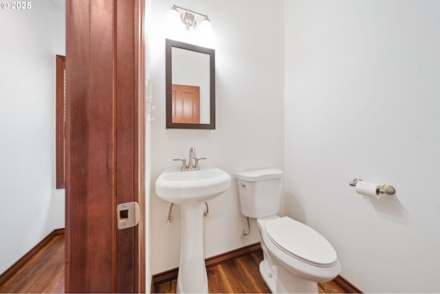 23072 SW Mansfield St, Sherwood, OR 97140 - half bathroom featuring toilet, wood finished floors, baseboards, and a sink
