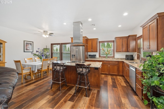 23072 SW Mansfield St, Sherwood, OR 97140 - kitchen with stainless steel appliances, a sink, island range hood, healthy amount of natural light, and recessed lighting