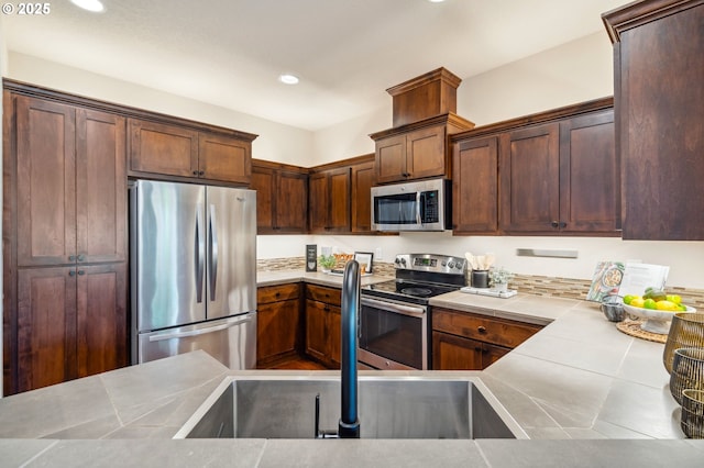 16125 SE Kingbird Dr, Clackamas, OR 97015 - kitchen with stainless steel appliances, recessed lighting, tile countertops, and a sink