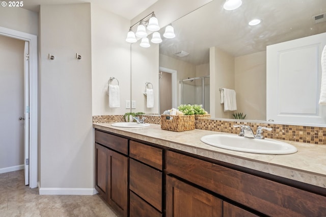 16125 SE Kingbird Dr, Clackamas, OR 97015 - bathroom featuring double vanity, a shower stall, baseboards, and tile patterned floors
