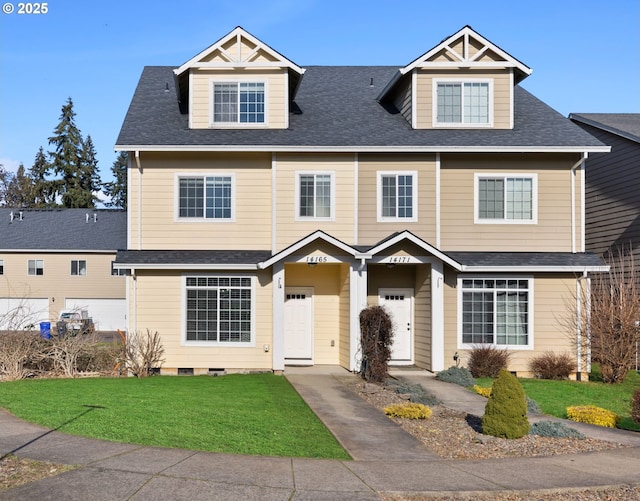 view of front of property featuring a shingled roof and a front yard