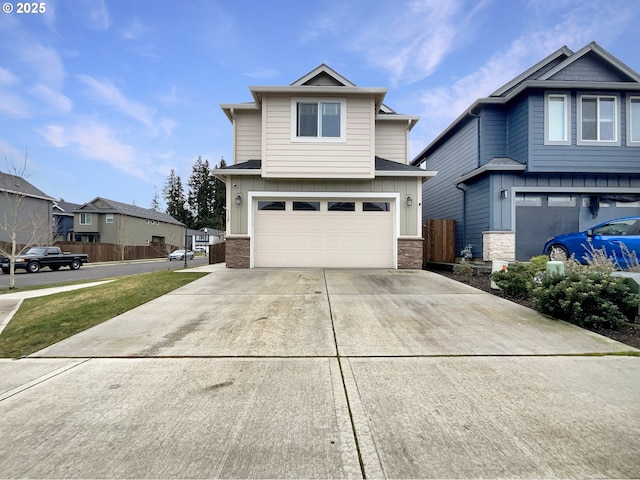 craftsman-style house with driveway, board and batten siding, an attached garage, and fence