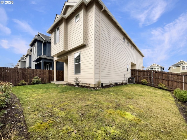 view of side of property featuring cooling unit, fence, and a lawn