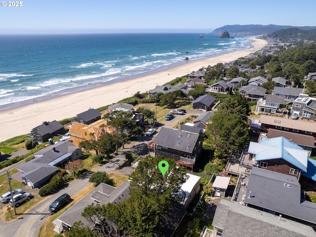 bird's eye view with a water view and a beach view