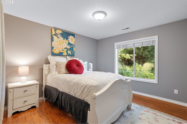 16904 SW Stellar Dr, Sherwood, OR 97140 - bedroom with wood finished floors, a textured ceiling, and baseboards