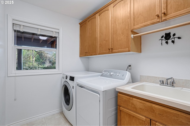 16904 SW Stellar Dr, Sherwood, OR 97140 - laundry area featuring washing machine and clothes dryer, cabinet space, light tile patterned floors, and baseboards