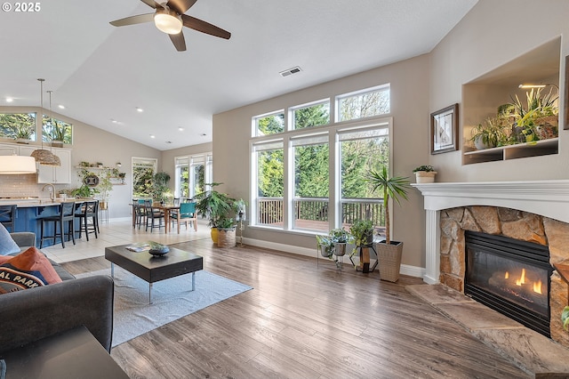 16904 SW Stellar Dr, Sherwood, OR 97140 - living room with ceiling fan, a fireplace, light wood finished floors, recessed lighting, and baseboards