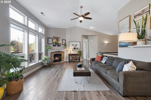 16904 SW Stellar Dr, Sherwood, OR 97140 - living room with a ceiling fan, lofted ceiling, a stone fireplace, and wood finished floors