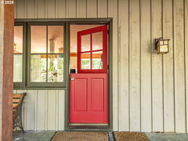 property entrance featuring board and batten siding