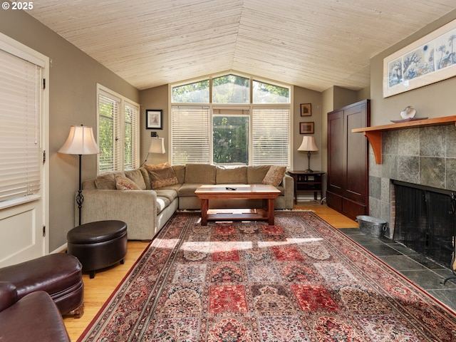 living room with light wood-style floors, wooden ceiling, a fireplace, and lofted ceiling