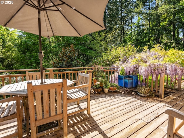 wooden deck featuring outdoor dining area
