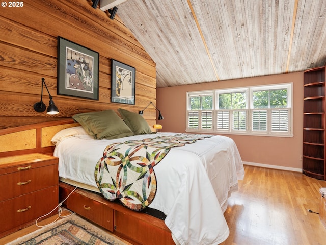 bedroom featuring wood finished floors, baseboards, wooden walls, wooden ceiling, and vaulted ceiling