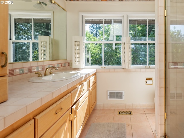 bathroom featuring backsplash, tile patterned floors, visible vents, and vanity