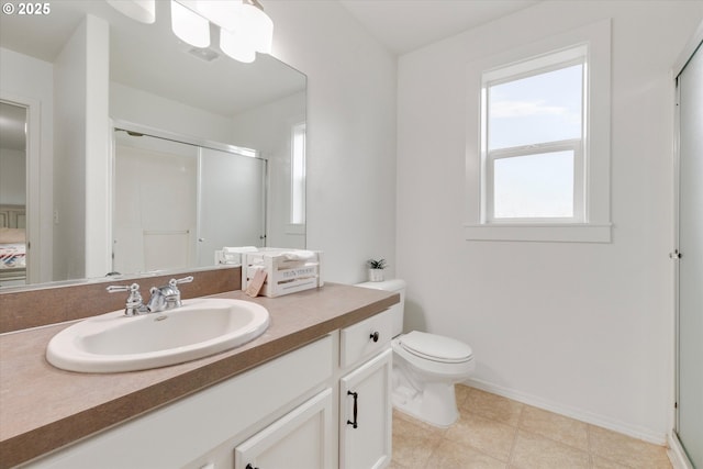 full bathroom with a shower stall, vanity, baseboards, and toilet