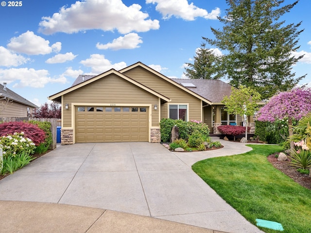 2231 SE Genesis Ct, Salem, OR 97306 - view of front facade featuring stone siding, driveway, and a garage