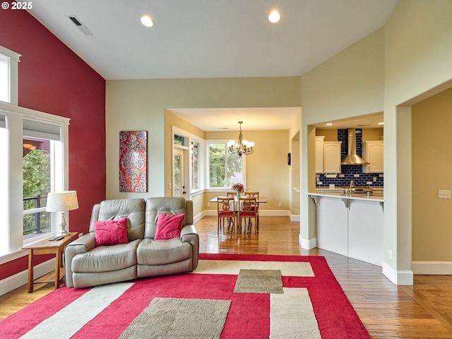 2231 SE Genesis Ct, Salem, OR 97306 - living room with wood finished floors, a chandelier, baseboards, and recessed lighting