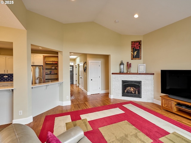 2231 SE Genesis Ct, Salem, OR 97306 - living area featuring light wood-style floors, recessed lighting, vaulted ceiling, a fireplace, and baseboards