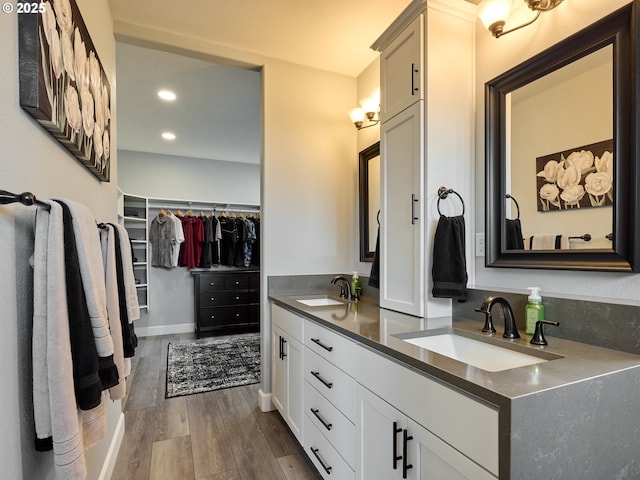 2231 SE Genesis Ct, Salem, OR 97306 - bathroom with wood finished floors, a walk in closet, double vanity, and recessed lighting