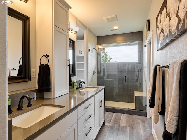 2231 SE Genesis Ct, Salem, OR 97306 - bathroom featuring a stall shower, double vanity, wood finished floors, and recessed lighting
