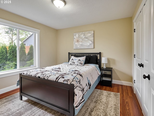 2231 SE Genesis Ct, Salem, OR 97306 - bedroom with a closet, multiple windows, baseboards, and a textured ceiling