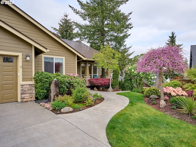2231 SE Genesis Ct, Salem, OR 97306 - property entrance featuring a lawn and stone siding