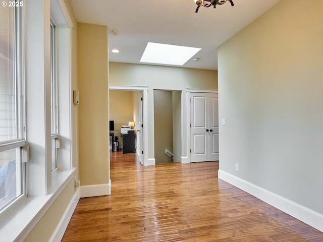 2231 SE Genesis Ct, Salem, OR 97306 - empty room featuring a skylight, light wood-type flooring, baseboards, and recessed lighting