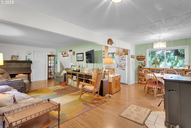 21161 S Upper Highland Rd, Beavercreek, OR 97004 - living area with a chandelier, stairway, and light wood-style flooring