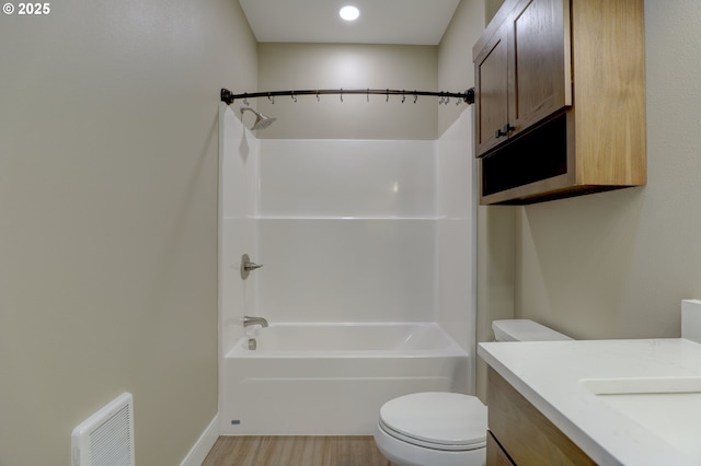 full bath featuring visible vents, toilet, washtub / shower combination, vanity, and wood finished floors