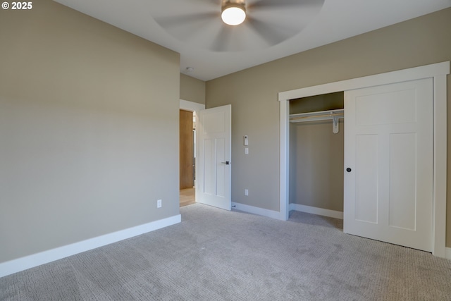 unfurnished bedroom with a ceiling fan, baseboards, a closet, and light colored carpet