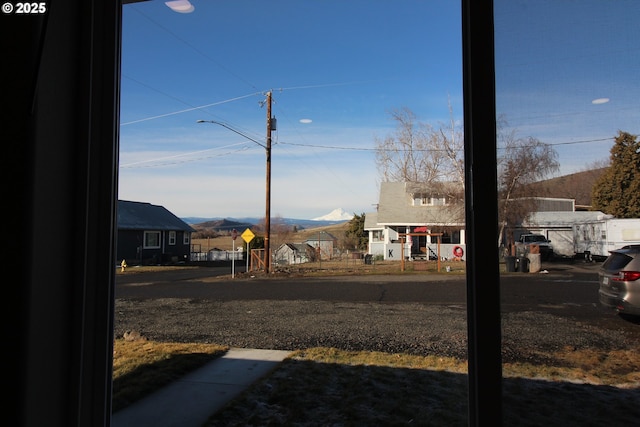 view of yard with a residential view and a mountain view