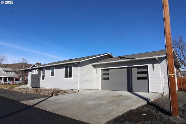 single story home featuring a garage and driveway