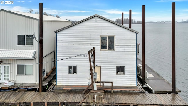 rear view of house featuring a water view