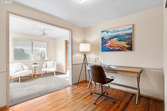 office area with hardwood / wood-style flooring, ceiling fan, and a textured ceiling