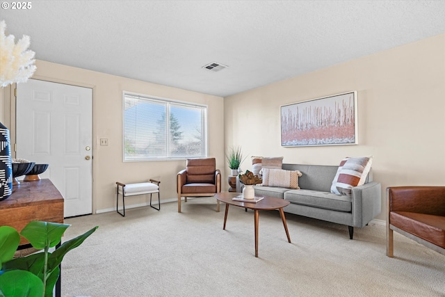 living room with light colored carpet and a textured ceiling