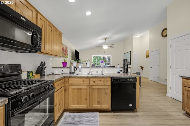 13417 NE 51st St, Vancouver, WA 98682 - kitchen with black appliances, a peninsula, decorative backsplash, lofted ceiling, and light wood-type flooring
