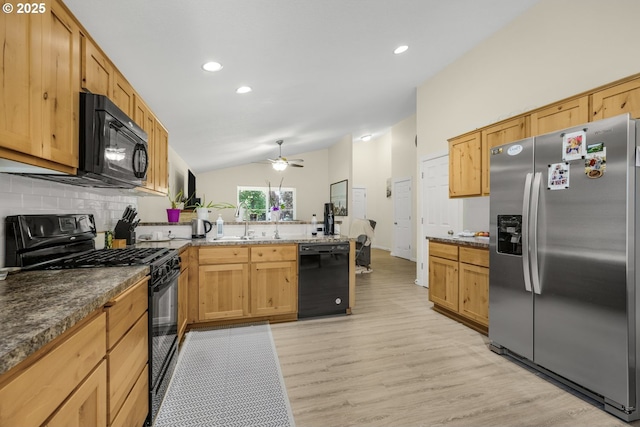 13417 NE 51st St, Vancouver, WA 98682 - kitchen with black appliances, a peninsula, lofted ceiling, decorative backsplash, and light wood-type flooring