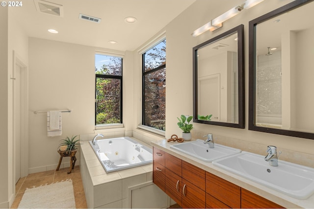 2172 NW 16th Ave, Portland, OR 97209 - bathroom with a whirlpool tub, tile patterned flooring, double vanity, recessed lighting, and baseboards
