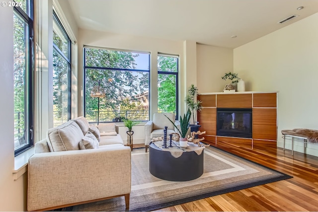 2172 NW 16th Ave, Portland, OR 97209 - living room featuring healthy amount of natural light, wood finished floors, and a glass covered fireplace