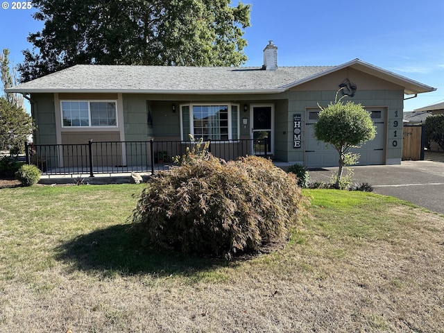 ranch-style home with a garage, driveway, a front lawn, and a chimney