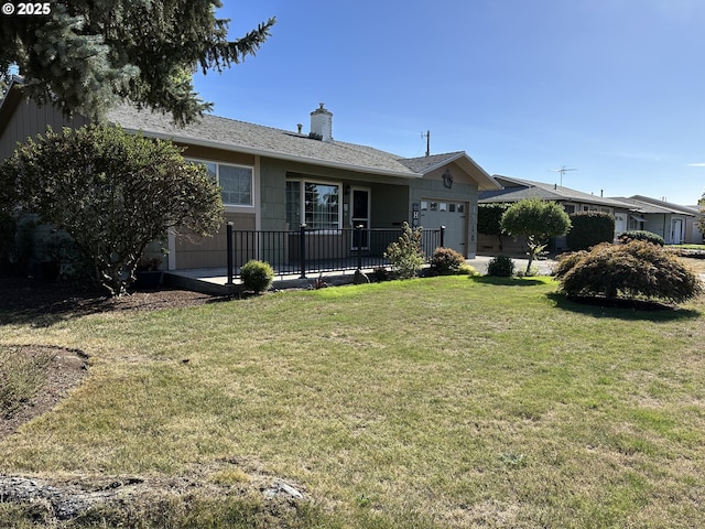 view of front of home with a garage, a front yard, and a chimney