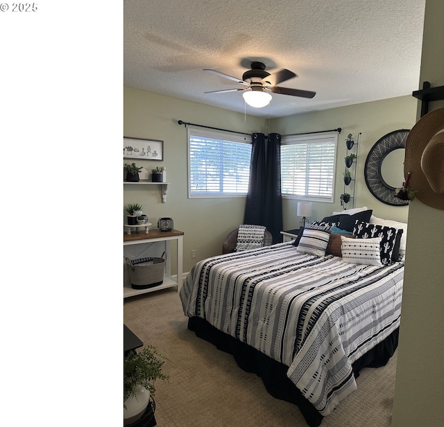 bedroom featuring a textured ceiling, carpet, and a ceiling fan