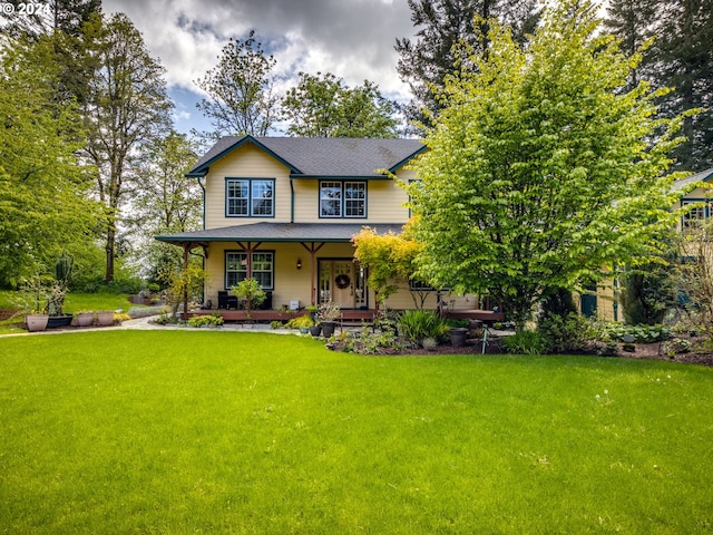 view of front facade featuring covered porch and a front lawn