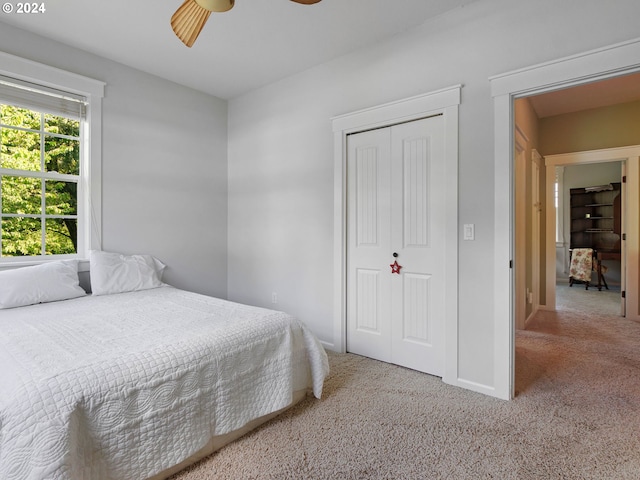 bedroom with carpet floors, a closet, a ceiling fan, and baseboards